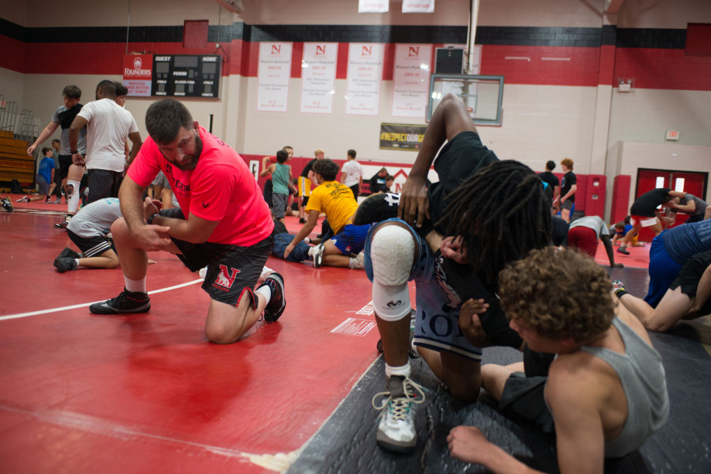 Group of wrestlers listening to instruction 
